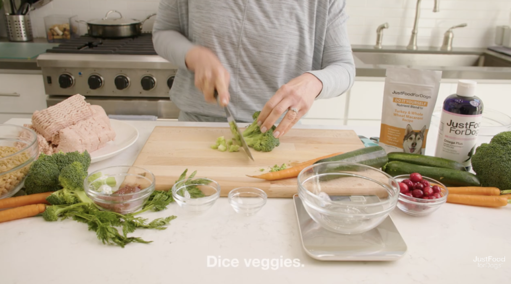 woman dicing veggies for homemade dog food